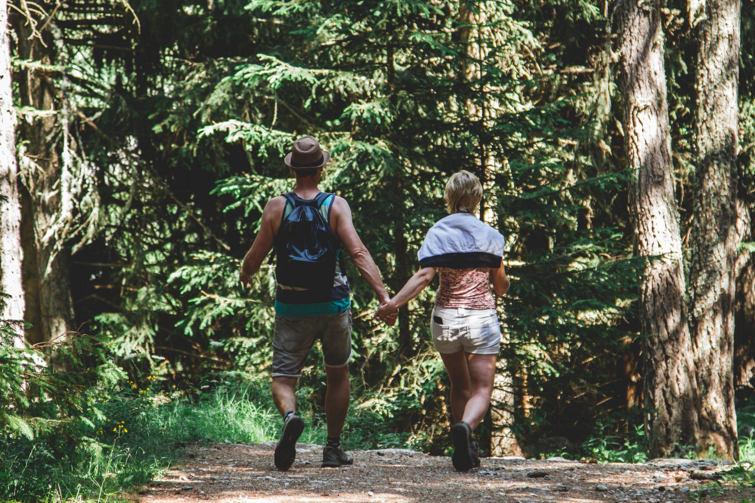 Canva - Man and Woman Walking in Forest